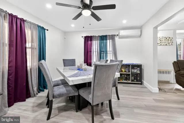 a view of a a dining room with furniture window and wooden floor