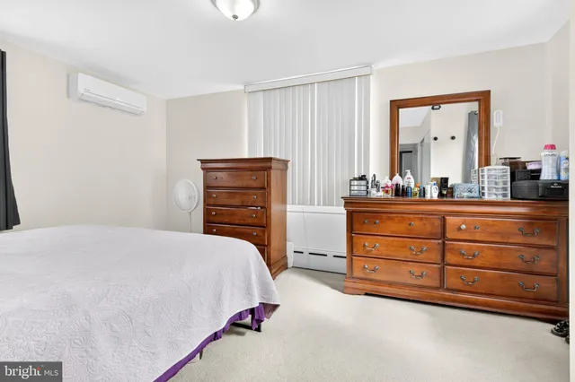 a bedroom with a bed couch and a window