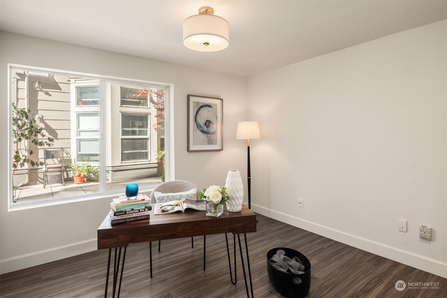 500 Aloha Street, Unit E111 Seattle, WA 98109 - Photo 15 of 25 a view of a workspace room with furniture and wooden floor