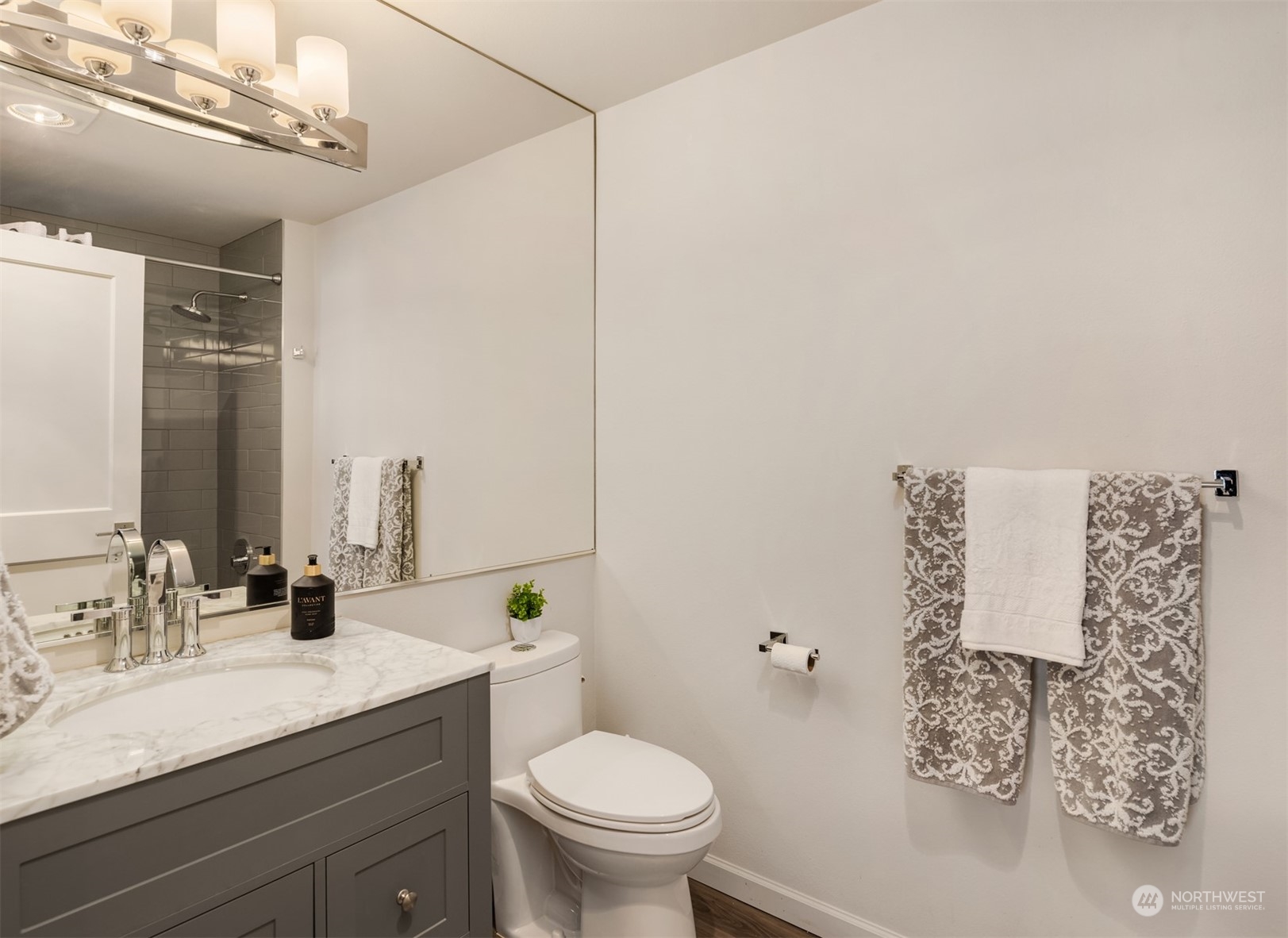500 Aloha Street, Unit E111 Seattle, WA 98109 - Photo 16 of 25 a bathroom with a granite countertop sink a toilet and a mirror