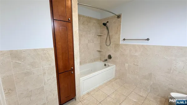 a bathroom with a bathtub and a shower