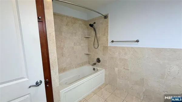 a spacious bathroom with a bathtub and a shower