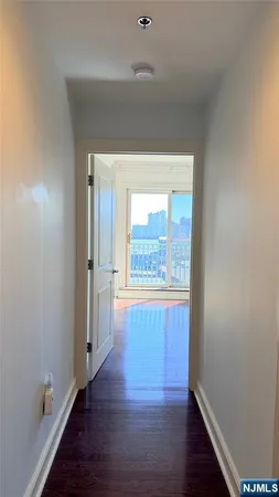 a view of hallway with wooden floor