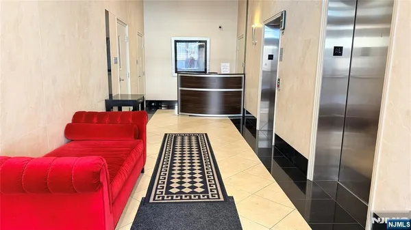a hallway with two chairs and a rug