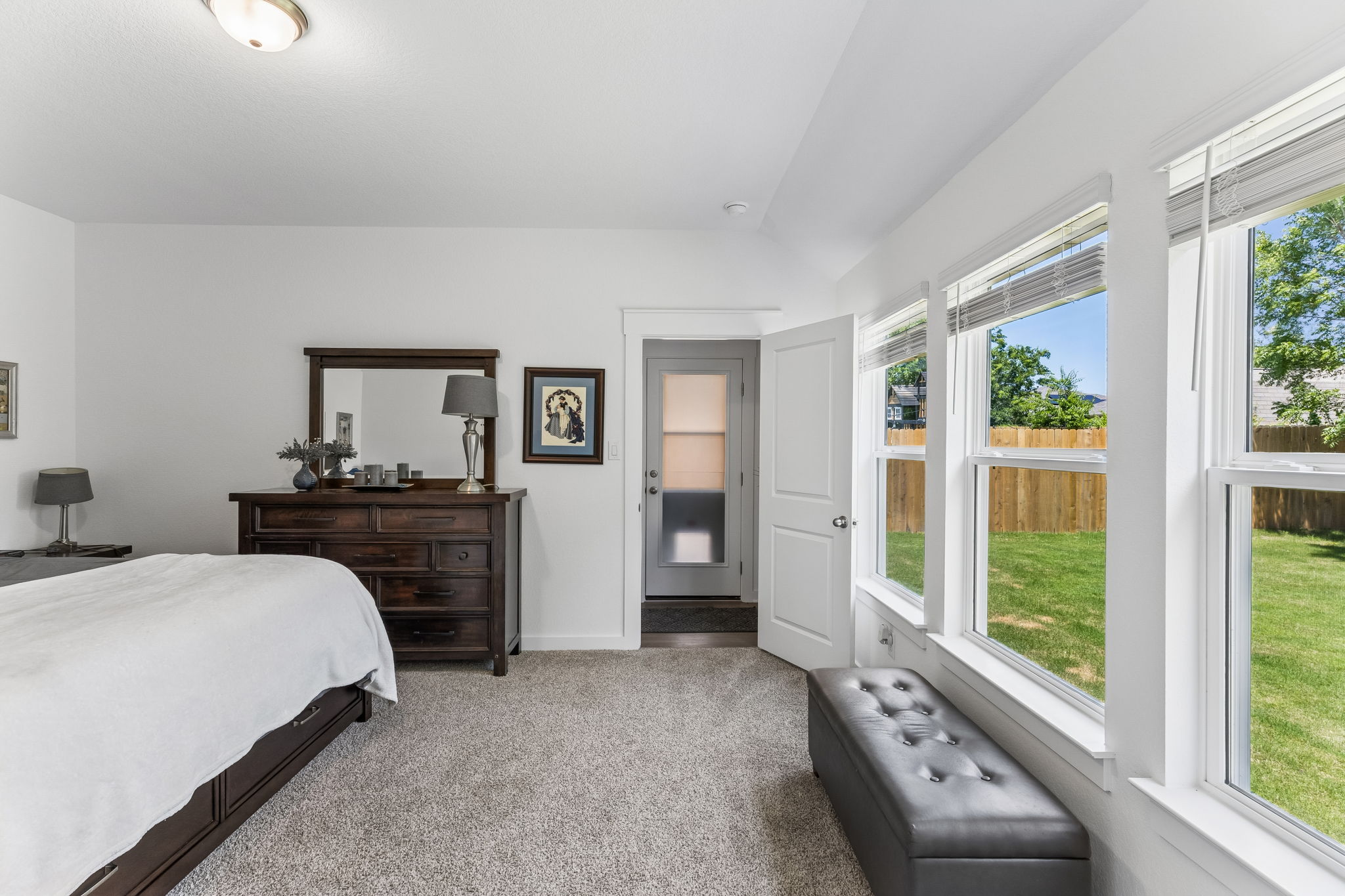 13509 Barn Chime Street Elgin, TX 78621 - Photo 22 of 40 Carpeted room featuring multiple large windows, a light-colored ceiling, and a white interior door