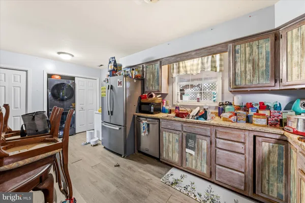 a kitchen with sink refrigerator and cabinets