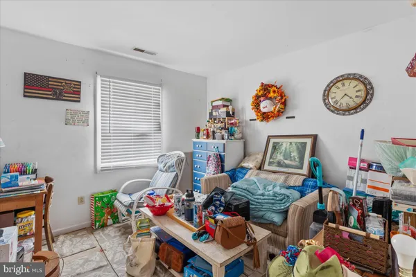 a living room with lots of furniture and a wooden floor
