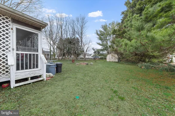 a view of backyard with deck and garden