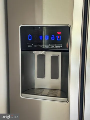 a view of a bedroom with a bed and wooden floor