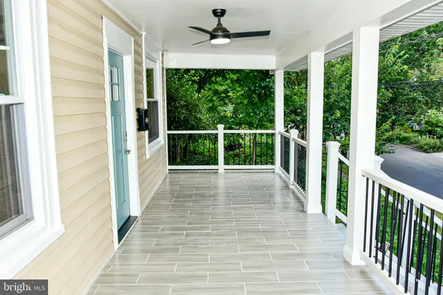 a living room with stainless steel appliances granite countertop furniture and a wooden floor