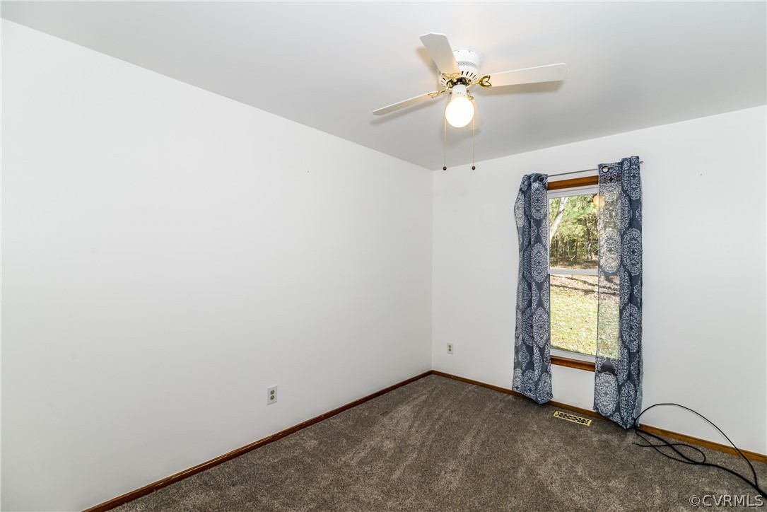 4217 Broad St Road Gum Spring, VA 23065 - Photo 15 of 39 an empty room with window and ceiling fan