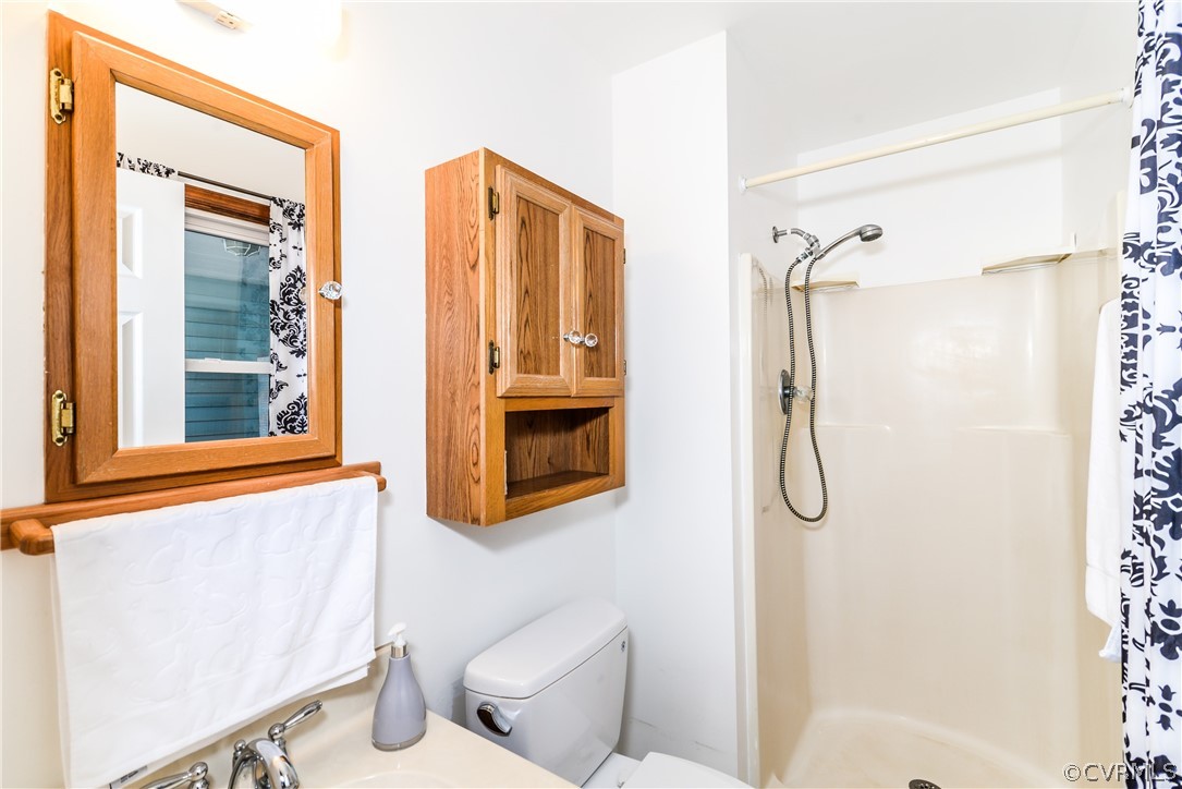 4217 Broad St Road Gum Spring, VA 23065 - Photo 18 of 39 a bathroom with a shower toilet and sink