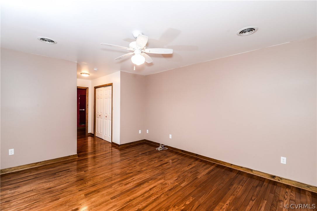 4217 Broad St Road Gum Spring, VA 23065 - Photo 24 of 39 a view of an empty room with wooden floor and a ceiling fan