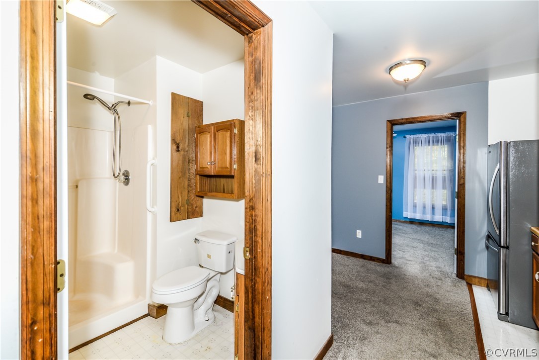 4217 Broad St Road Gum Spring, VA 23065 - Photo 25 of 39 a bathroom with a glass door shower and a toilet