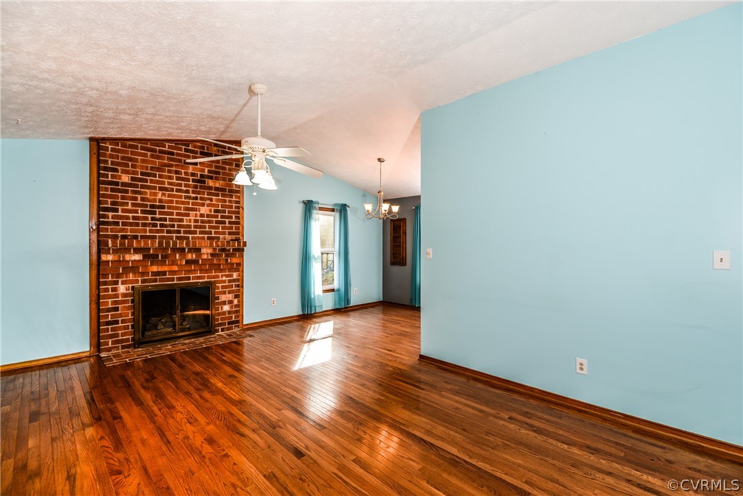 4217 Broad St Road Gum Spring, VA 23065 - Photo 8 of 39 an empty room with wooden floor fireplace and windows