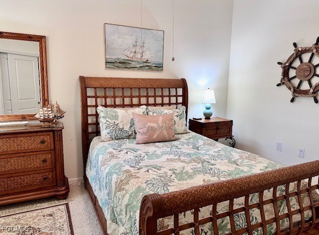 10470 Casella Way, Unit 102 Fort Myers, FL 33913 - Photo 9 of 18 a bed sitting in a bedroom next to a window