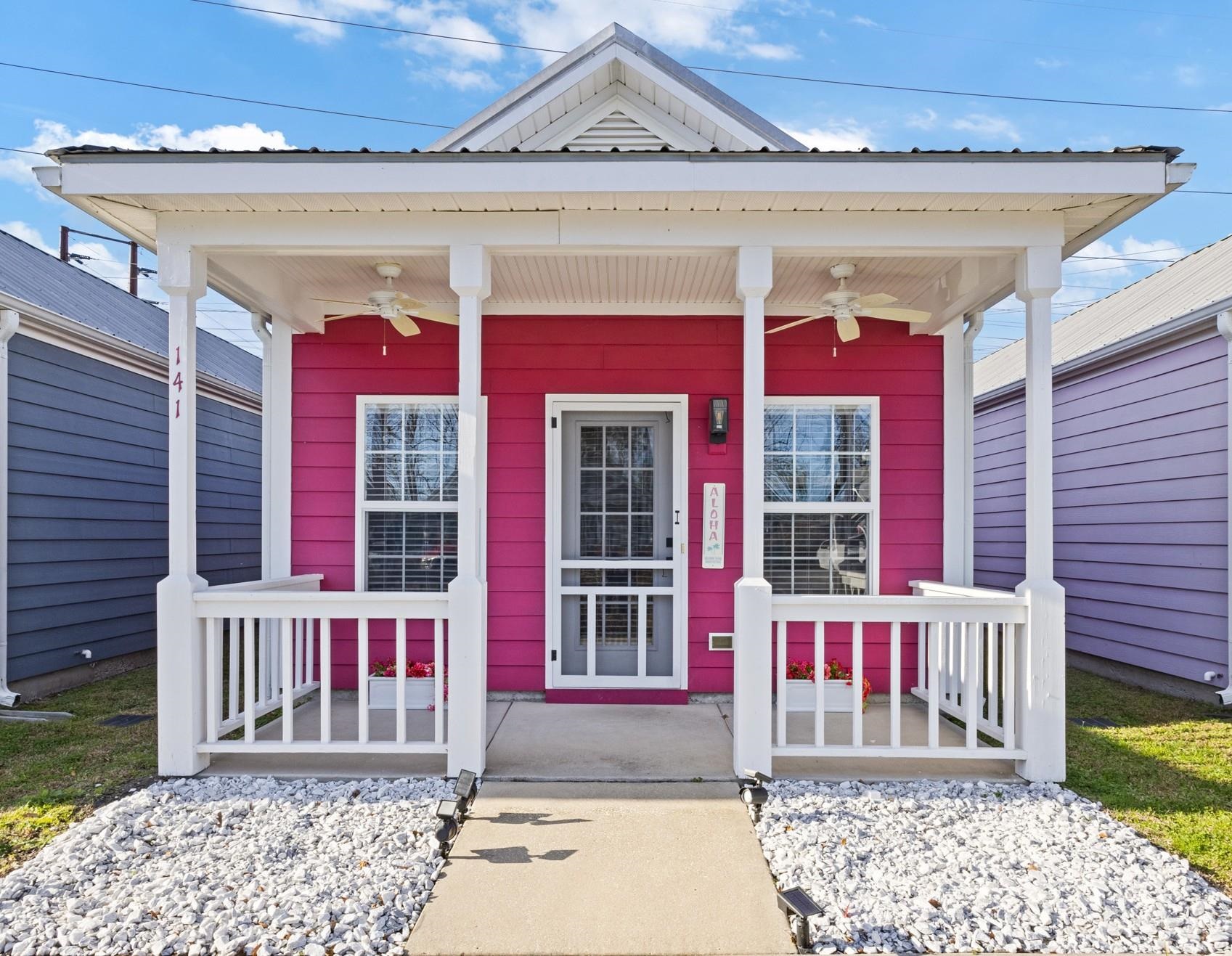 View of exterior entry featuring a porch and a ceiling fan