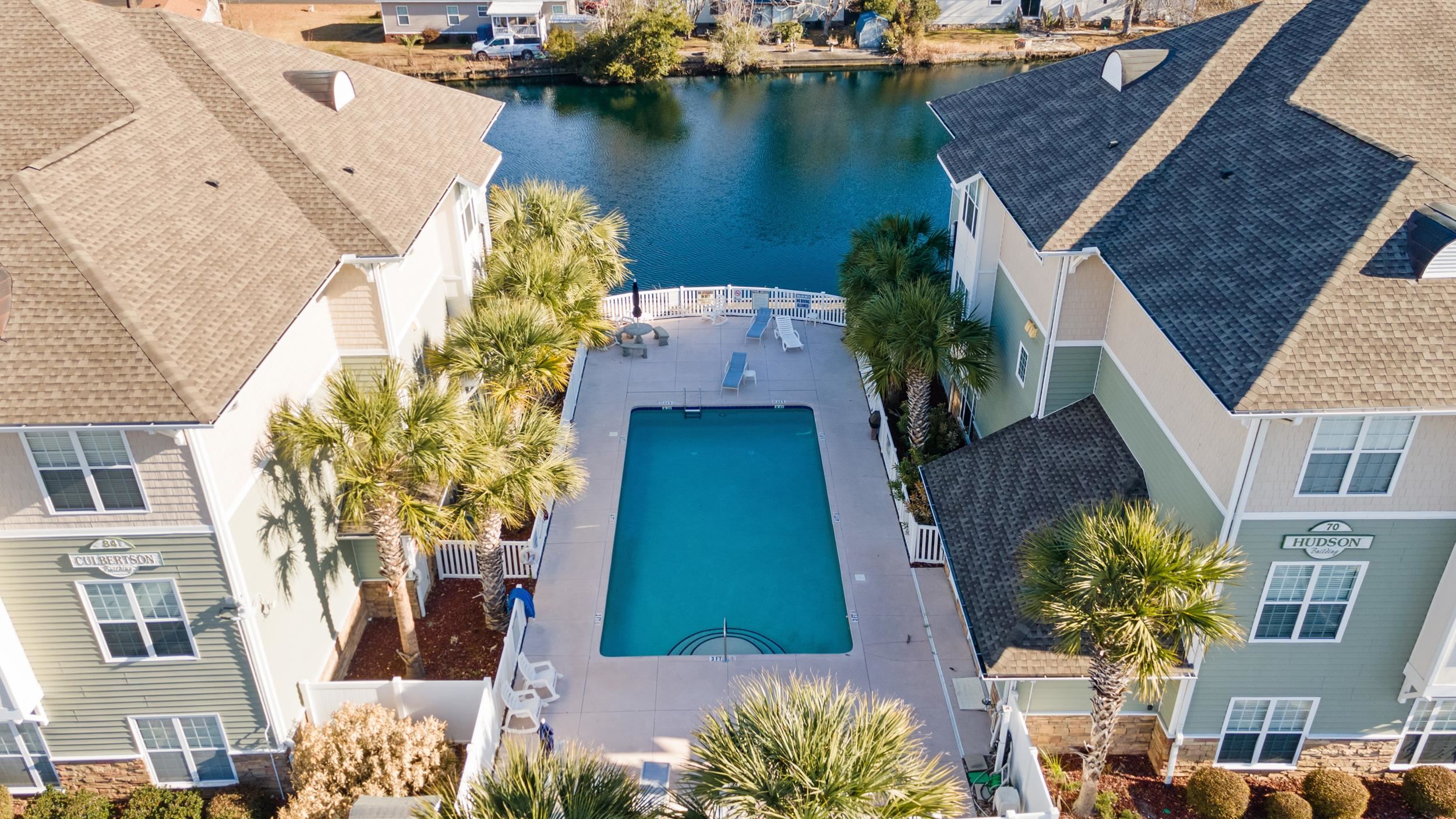 141 Addison Cottage Way Murrells Inlet, SC 29576 - Photo 15 of 17 Aerial perspective of suburban area with a nearby body of water and a pool area