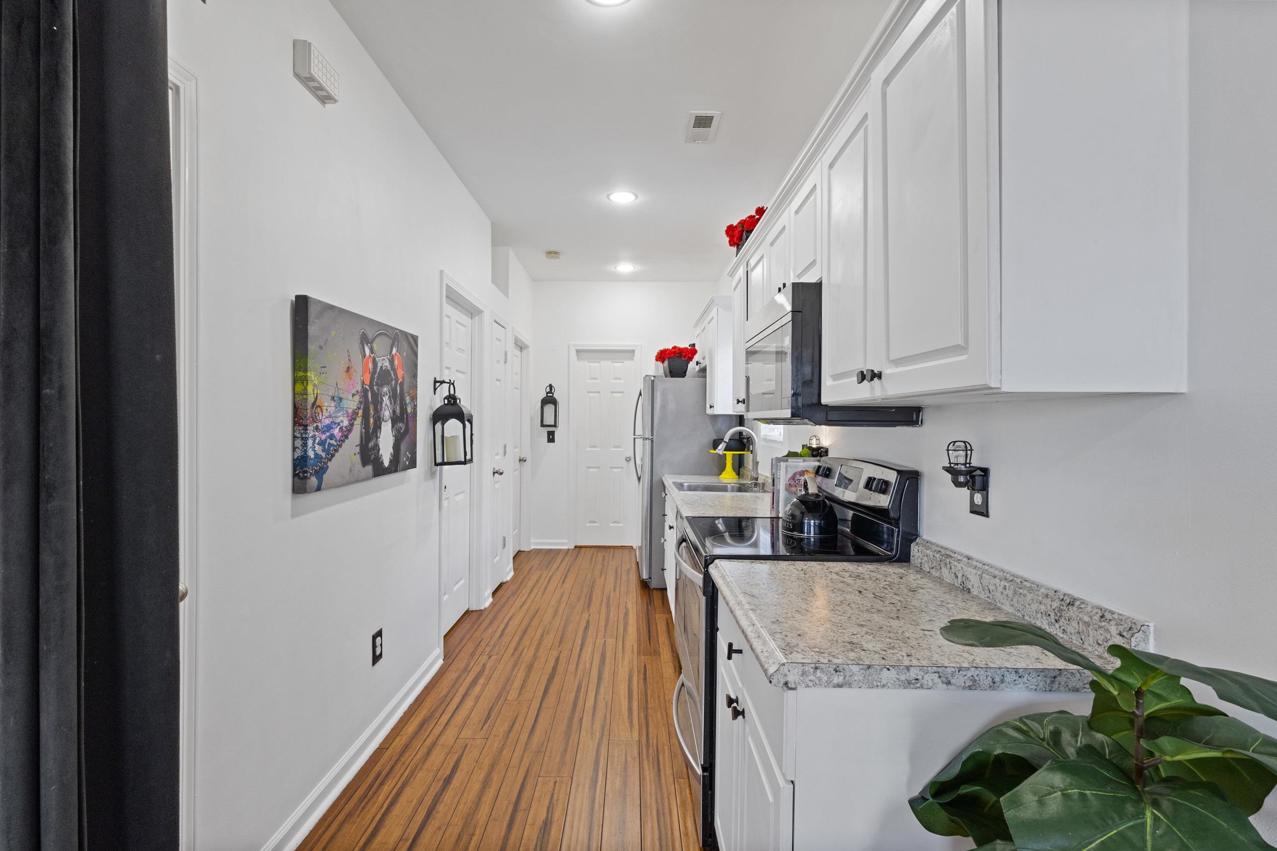 141 Addison Cottage Way Murrells Inlet, SC 29576 - Photo 6 of 17 Kitchen with white cabinetry, appliances with stainless steel finishes, light countertops, dark wood-style flooring, and recessed lighting