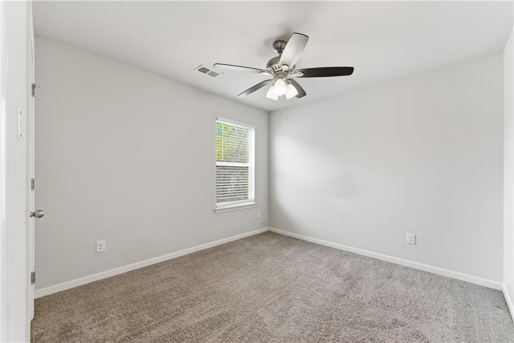 6771 Mason Lane Rex, GA 30273 - Photo 22 of 30 an empty room with windows and fan