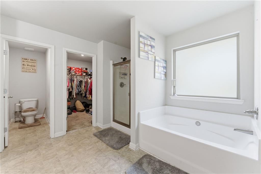 6771 Mason Lane Rex, GA 30273 - Photo 27 of 30 a bathroom with a tub and shower