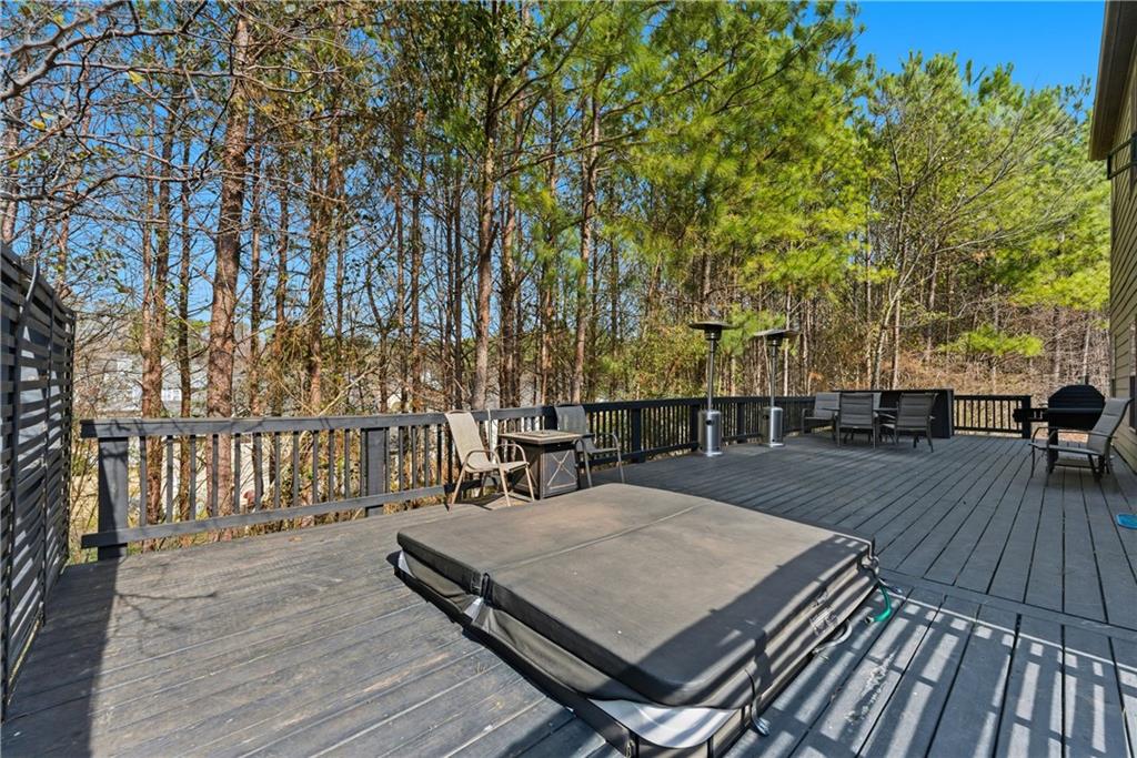 6771 Mason Lane Rex, GA 30273 - Photo 29 of 30 a view of a roof deck with table and chairs a barbeque with wooden floor and fence