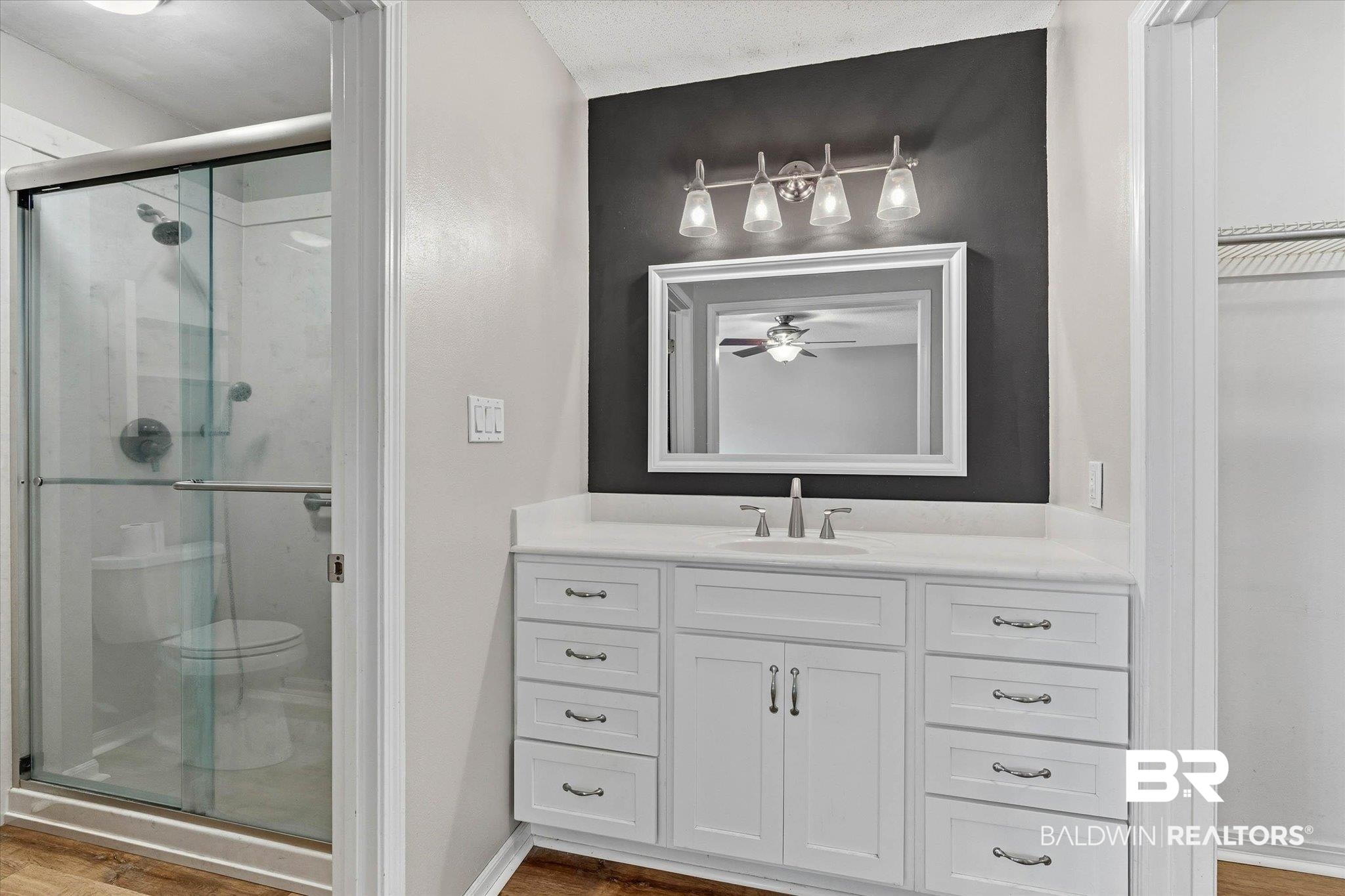 8030 Country Drive Mobile, AL 36619 - Photo 11 of 22 Bathroom with vanity, a stall shower, and light wood-type flooring