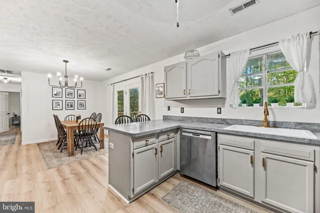 a kitchen with a sink stove and cabinets