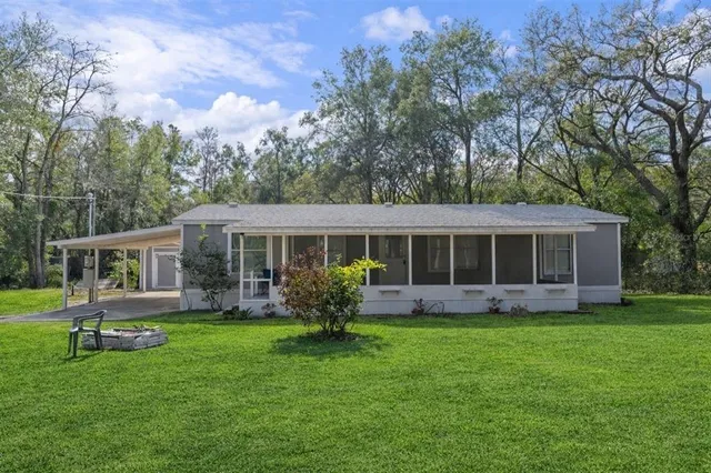 a front view of house with yard and green space