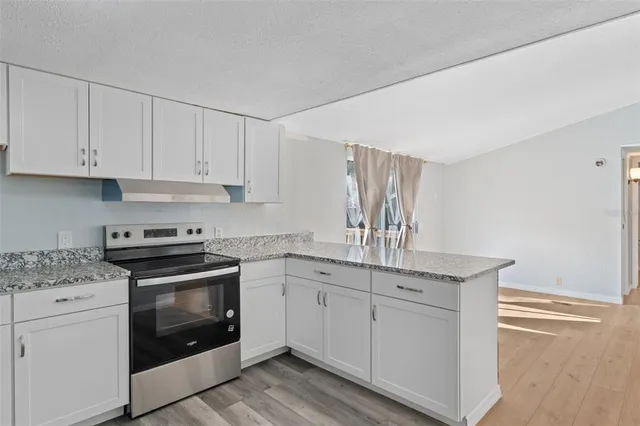 a kitchen with appliances cabinets and a sink