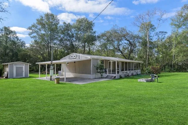 a front view of house with a garden and deck