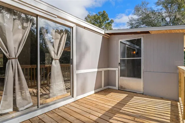 a view of front door and deck of the house