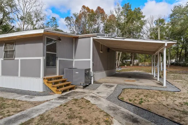 a view of a patio with table and chairs with wooden floor and fence