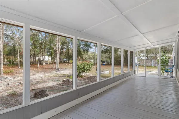 a view of a room with wooden floor and windows