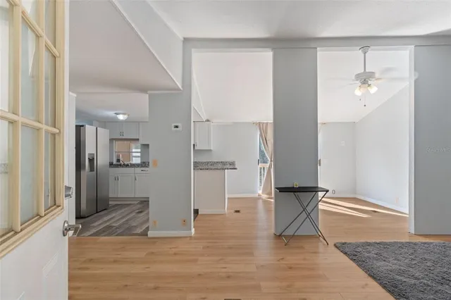 a view of a kitchen and an empty room