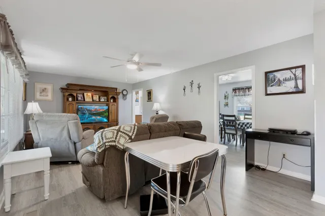 a view of a dining room with furniture and wooden floor