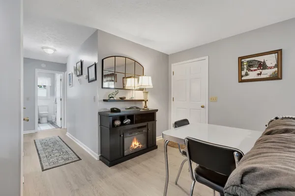a living room with furniture a rug and a window