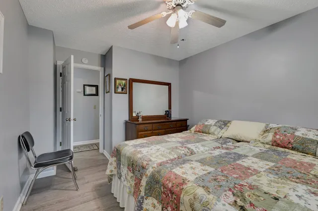 a bedroom with a large bed and a chandelier