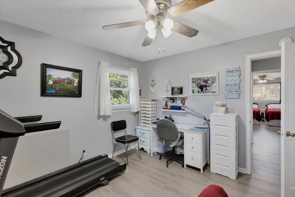 a view of a workspace with furniture and a window
