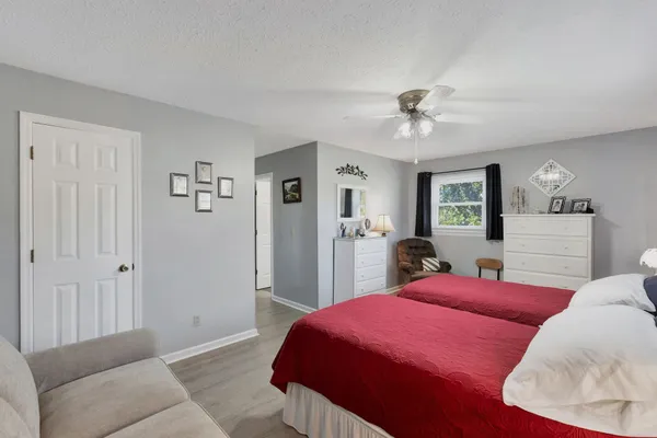 a bedroom with a bed and a chandelier