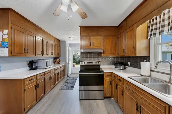 a kitchen with stainless steel appliances granite countertop a stove a sink dishwasher and a refrigerator