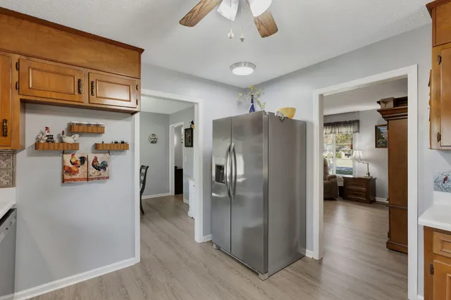 a kitchen with stainless steel appliances granite countertop a refrigerator and a sink