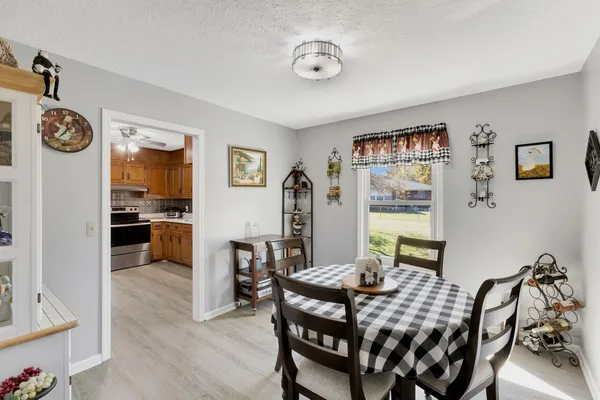 a view of a dining room with furniture and a large window
