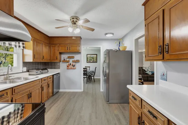 a kitchen with wooden cabinets and stainless steel appliances