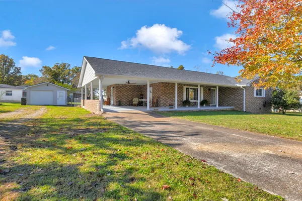 a view of a house with swimming pool and a yard