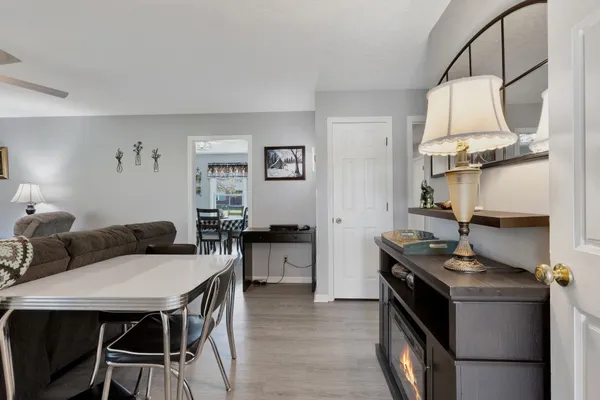 a kitchen with stainless steel appliances kitchen island a table and chairs in it