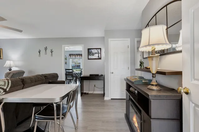 a kitchen with stainless steel appliances kitchen island a table and chairs in it