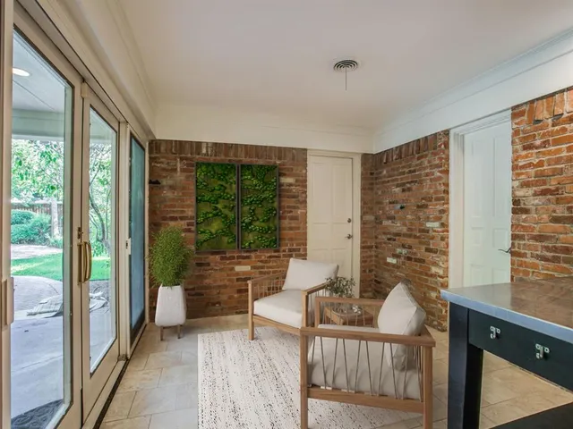 a living room with furniture and large windows