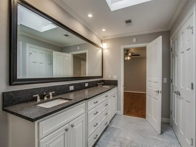 a bathroom with a double vanity sink and a mirror