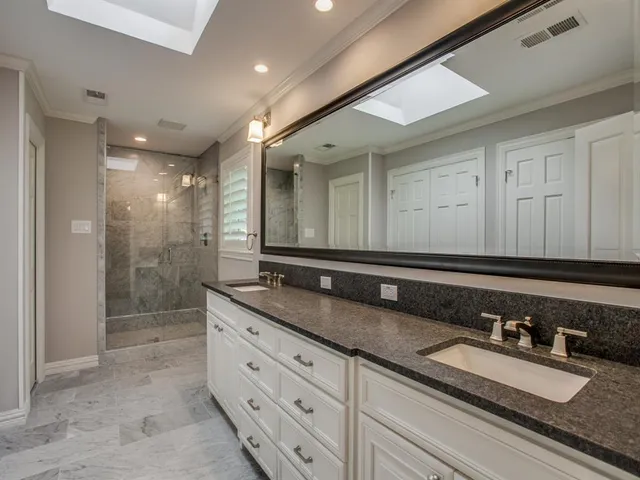 a bathroom with double sink and a mirror
